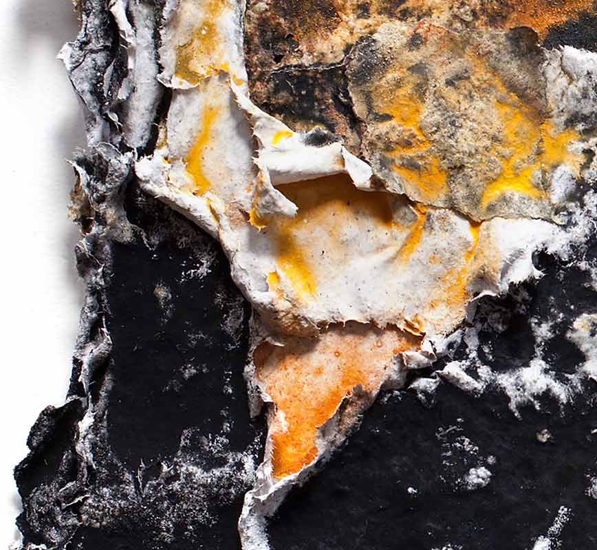 Detail of an abstract textural work on paper tridimentionally cast by the artist. Mainly orange and black colors. Title: Charta: Ater, Gilvus et Flavus