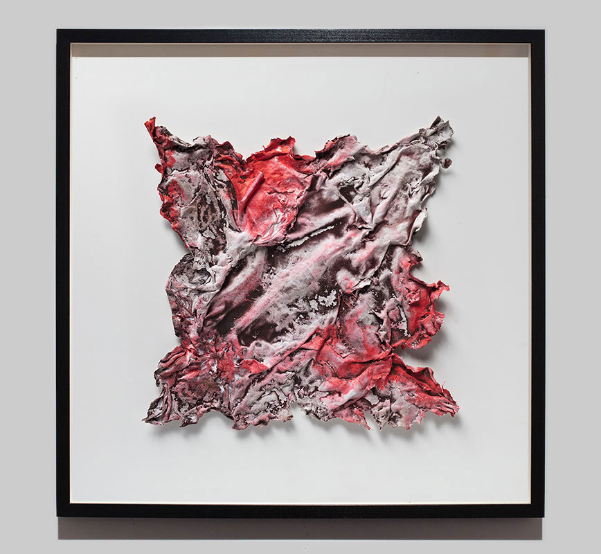 Framed abstract textural work on paper tridimentionally cast by the artist. Mainly red and brown colors. Title: Pompeii Papyrus