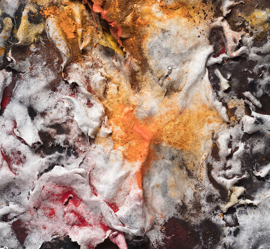 Detail of an abstract textural work on paper tridimentionally cast by the artist. Mainly orange and black colors. Title: Flammae Tenebrosae (Fires in the Darkness)