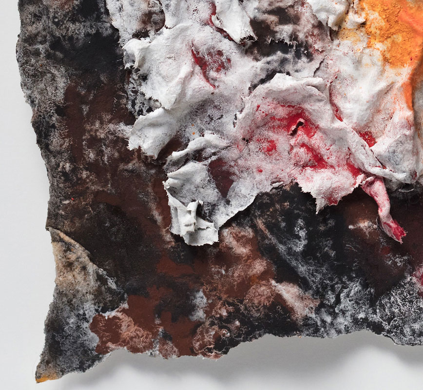 Detail of an abstract textural work on paper tridimentionally cast by the artist. Mainly orange and black colors. Title: Flammae Tenebrosae (Fires in the Darkness)