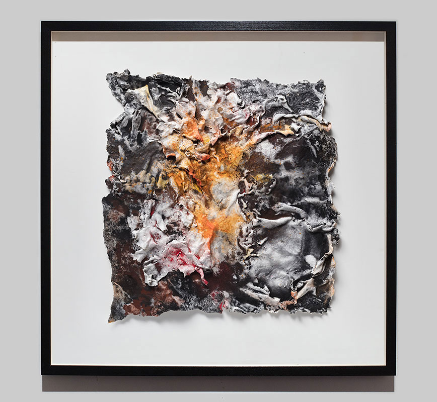 Framed abstract textural work on paper tridimentionally cast by the artist. Mainly orange and black colors. Title: Flammae Tenebrosae (Fires in the Darkness)