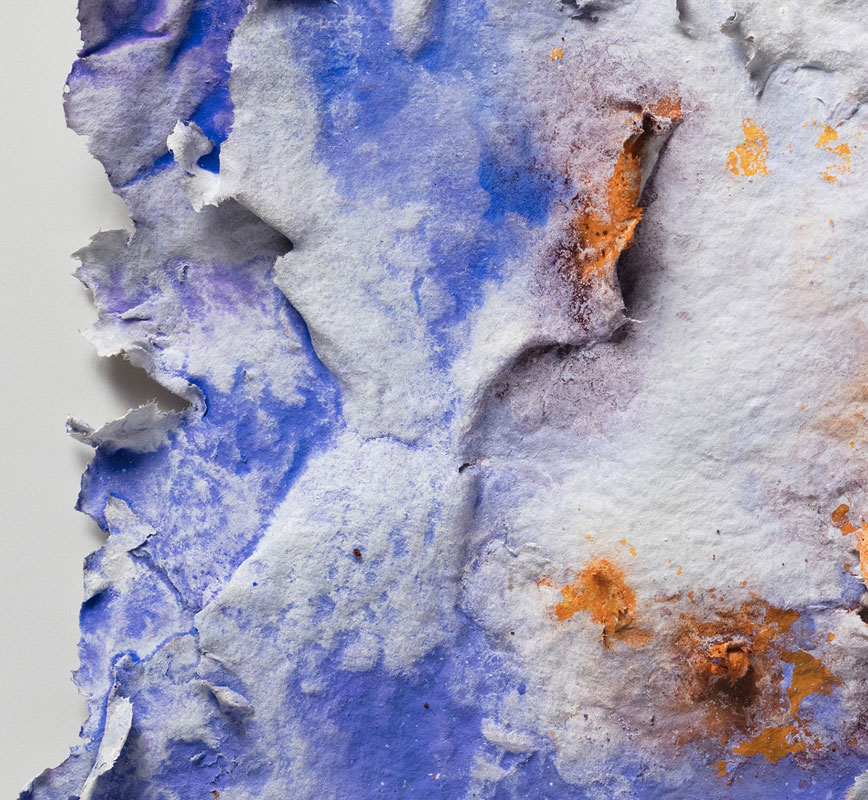 Detail of an abstract textural work on paper tridimentionally cast by the artist. Mainly blue and orange colors. Title: Aurora Brumalis (Winter Dawn)